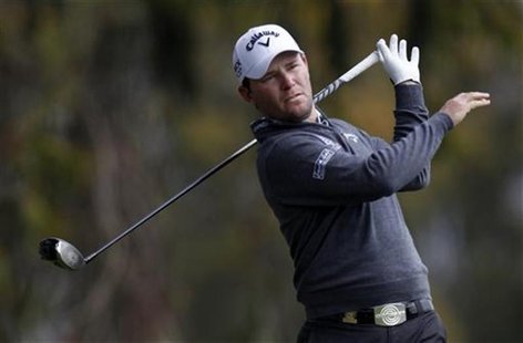 Branden Grace of South Africa drops his club while teeing off on the second hole during the first round for the 2012 U.S. Open golf tourname Branden Grace of South Africa drops his club while teeing off on the second hole during the first round for the 2012 U.S. Open golf tourname