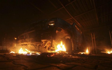A burning car is seen at the U.S. Consulate in Benghazi during a protest by an armed group said to have been protesting a film being produce A burning car is seen at the U.S. Consulate in Benghazi during a protest by an armed group said to have been protesting a film being produce