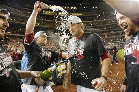 Washington Nationals pitcher Ross Detwiler (center) celebrates with teammates on the field after clinching their National League East Divisi Washington Nationals pitcher Ross Detwiler (center) celebrates with teammates on the field after clinching their National League East Divisi