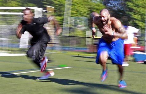Jyles Tucker (R) and Legedu Naanee run sprints during workouts with other NFL hopefuls at the Bommarito Performance Systems facility in Nort Jyles Tucker (R) and Legedu Naanee run sprints during workouts with other NFL hopefuls at the Bommarito Performance Systems facility in Nort