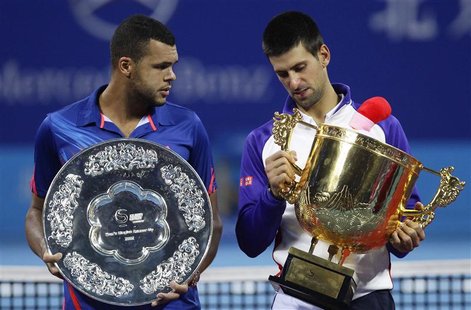 Serbia's Novak Djokovic (R) stands with France's Jo-Wilfried Tsonga with their trophies after winning the men's singles final at the China O Serbia's Novak Djokovic (R) stands with France's Jo-Wilfried Tsonga with their trophies after winning the men's singles final at the China O