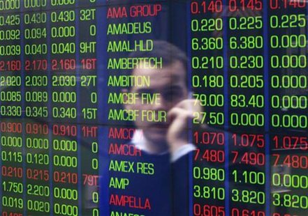 An office worker talks on his phone as he looks the stock board at the Australian Securities Exchange (ASX) building in central Sydney June An office worker talks on his phone as he looks the stock board at the Australian Securities Exchange (ASX) building in central Sydney June