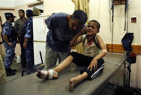 A wounded Palestinian boy speaks on the phone with his family following an Israeli air strike in Rafah camp in the southern Gaza Strip Octob A wounded Palestinian boy speaks on the phone with his family following an Israeli air strike in Rafah camp in the southern Gaza Strip Octob