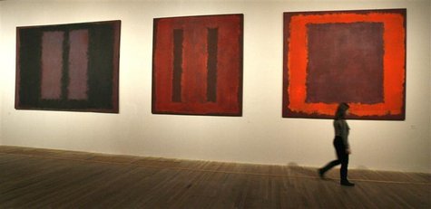 A gallery worker walks past Seagram murals by Russian-born American painter Mark Rothko during a media view of the first major exhibition de A gallery worker walks past Seagram murals by Russian-born American painter Mark Rothko during a media view of the first major exhibition de
