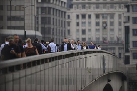 Commuters walk towards the financial district via London Bridge, three days after the end of the London 2012 Olympics August 15, 2012. REUTE Commuters walk towards the financial district via London Bridge, three days after the end of the London 2012 Olympics August 15, 2012. REUTE