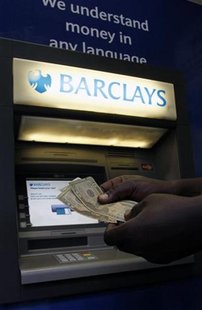 A man withdraws U.S. Dollar notes form a Barclays automated teller machine (ATM) in the capital Harare July 3, 2012. REUTERS/Philimon Bulawa A man withdraws U.S. Dollar notes form a Barclays automated teller machine (ATM) in the capital Harare July 3, 2012. REUTERS/Philimon Bulawa