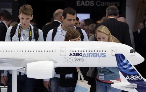 Visitors look at an A350 aircraft miniature at the EADS booth during the ILA Berlin Air Show in Selchow near Schoenefeld south of Berlin on Visitors look at an A350 aircraft miniature at the EADS booth during the ILA Berlin Air Show in Selchow near Schoenefeld south of Berlin on