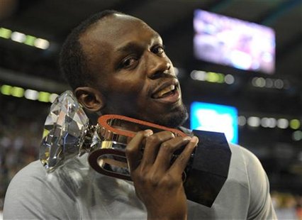 Usain Bolt of Jamaica poses with his trophy after competing in the men's 100m event at the IAAF Diamond League athletics meeting, also known Usain Bolt of Jamaica poses with his trophy after competing in the men's 100m event at the IAAF Diamond League athletics meeting, also known