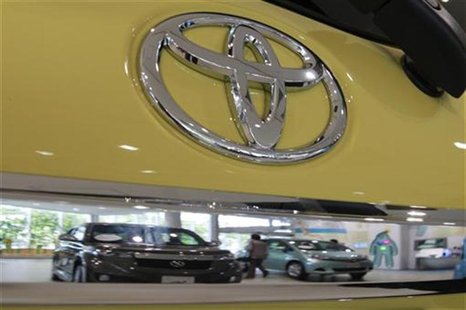 A visitor is reflected in a Toyota Motor Corp's vehicle displayed at the company's showroom in Tokyo September 26, 2012. REUTERS/Yuriko Naka A visitor is reflected in a Toyota Motor Corp's vehicle displayed at the company's showroom in Tokyo September 26, 2012. REUTERS/Yuriko Naka