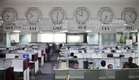 Workers are pictured beneath clocks displaying time zones in various parts of the world at an outsourcing centre in Bangalore February 29, 2 Workers are pictured beneath clocks displaying time zones in various parts of the world at an outsourcing centre in Bangalore February 29, 2