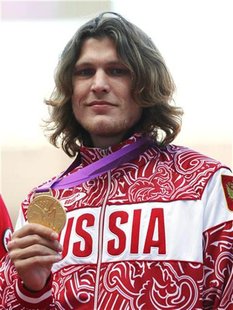 Russian's Ivan Ukhov holds up his gold medal for men's high jump in London at the London 2012 Olympic Games at the Olympic Stadium August 8, Russian's Ivan Ukhov holds up his gold medal for men's high jump in London at the London 2012 Olympic Games at the Olympic Stadium August 8,