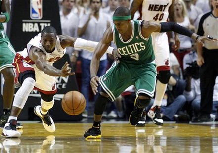 Miami Heat's Dwyane Wade (L) fights for a loose ball with Boston Celtics' Rajon Rondo in the third quarter during Game 7 of their Eastern Co Miami Heat's Dwyane Wade (L) fights for a loose ball with Boston Celtics' Rajon Rondo in the third quarter during Game 7 of their Eastern Co