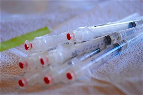 Doses of a flu vaccine lie on a table as San Luis Obispo County public healthcare professionals conduct a mass flu vaccination drill at the Doses of a flu vaccine lie on a table as San Luis Obispo County public healthcare professionals conduct a mass flu vaccination drill at the