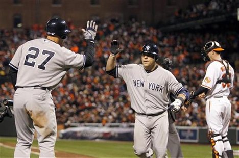 New York Yankees' Russell Martin (C) is congratulated by his teammate Raul Ibanez (L) after Martin hit a solo home run in the ninth inning a New York Yankees' Russell Martin (C) is congratulated by his teammate Raul Ibanez (L) after Martin hit a solo home run in the ninth inning a