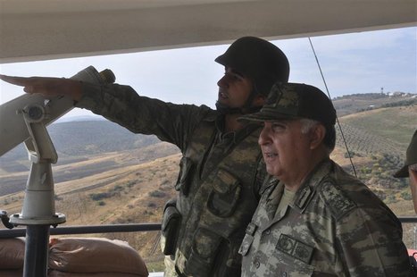 Turkey's Chief of General Staff Necdet Ozel (R) receives information during his visit at a border outpost on the Turkish-Syrian border in Ha Turkey's Chief of General Staff Necdet Ozel (R) receives information during his visit at a border outpost on the Turkish-Syrian border in Ha