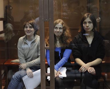 Members of the female punk band "Pussy Riot" (L-R) Yekaterina Samutsevich, Maria Alyokhina and Nadezhda Tolokonnikova sit in a glass-walled Members of the female punk band "Pussy Riot" (L-R) Yekaterina Samutsevich, Maria Alyokhina and Nadezhda Tolokonnikova sit in a glass-walled