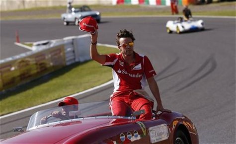 Ferrari Formula One driver Fernando Alonso of Spain waves during the driver's parade of the Japanese F1 Grand Prix at the Suzuka circuit Oct Ferrari Formula One driver Fernando Alonso of Spain waves during the driver's parade of the Japanese F1 Grand Prix at the Suzuka circuit Oct