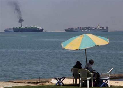 A family sits at the beach in Fayed at Ismailiya near the Suez Canal, some 120 km (75 miles) north of Cairo in this April 16, 2012 file phot A family sits at the beach in Fayed at Ismailiya near the Suez Canal, some 120 km (75 miles) north of Cairo in this April 16, 2012 file phot