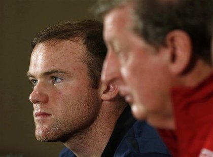 England's national soccer team manager Roy Hodgson (R) and captain Wayne Rooney attend a media conference at the team's hotel in Watford, no England's national soccer team manager Roy Hodgson (R) and captain Wayne Rooney attend a media conference at the team's hotel in Watford, no