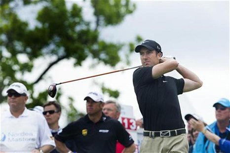 Britain's Ross Fisher tees off the first hole during the fourth and last round of the Nordea Masters golf tournament at Bro Hof golf club in Britain's Ross Fisher tees off the first hole during the fourth and last round of the Nordea Masters golf tournament at Bro Hof golf club in