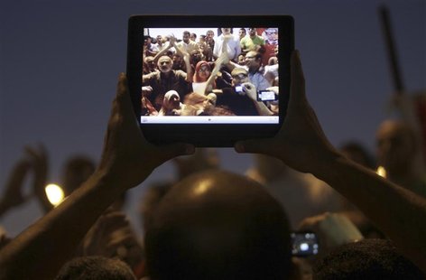 Egyptian protesters are pictured on a tablet device during a protest against general prosecutor Abdel Maguid Mahmoud and the Mubarak regime Egyptian protesters are pictured on a tablet device during a protest against general prosecutor Abdel Maguid Mahmoud and the Mubarak regime