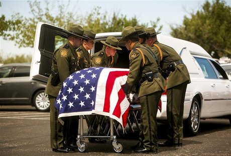 Law enforcement colleagues of U.S. Border Patrol agent Nicholas Ivie, 30, prepare to lift his casket into a hearse during his funeral in Sie Law enforcement colleagues of U.S. Border Patrol agent Nicholas Ivie, 30, prepare to lift his casket into a hearse during his funeral in Sie