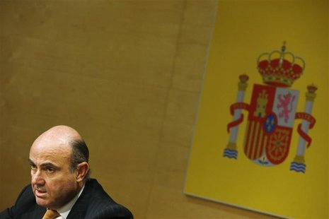 Spanish Economy Minister Luis de Guindos attends a news conference with European Economic and Monetary Affairs Commissioner Olli Rehn (not p Spanish Economy Minister Luis de Guindos attends a news conference with European Economic and Monetary Affairs Commissioner Olli Rehn (not p