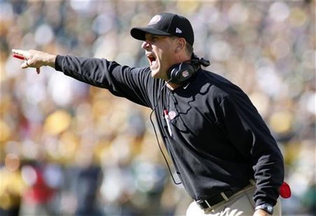 San Francisco 49ers head coach Jim Harbaugh reacts after his team was called with a penalty against the Green Bay Packers in the first half San Francisco 49ers head coach Jim Harbaugh reacts after his team was called with a penalty against the Green Bay Packers in the first half