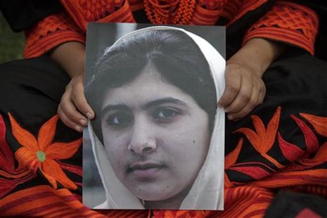 A student holds an image of Malala Yousufzai, who was shot on Tuesday by the Taliban, during a rally in Lahore October 14, 2012. REUTERS/Moh A student holds an image of Malala Yousufzai, who was shot on Tuesday by the Taliban, during a rally in Lahore October 14, 2012. REUTERS/Moh