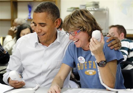 U.S. President Barack Obama (L) sits with campaign volunteer Suzanne Stern as he makes calls from a campaign office in Williamsburg, Virgini U.S. President Barack Obama (L) sits with campaign volunteer Suzanne Stern as he makes calls from a campaign office in Williamsburg, Virgini