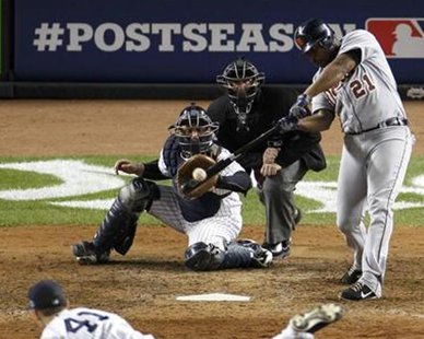 Detroit Tigers' DH Delmon Young hits an RBI double off New York Yankees relief pitcher David Phelps as catcher Russell Martin looks on during the 12th inning of Game 1 of their MLB ALCS playoff baseball series in New York, October 13, 2012. REUTERS/Bill Kostroun Detroit Tigers' DH Delmon Young hits an RBI double off New York Yankees relief pitcher David Phelps as catcher Russell Martin looks on during the 12th inning of Game 1 of their MLB ALCS playoff baseball series in New York, October 13, 2012. REUTERS/Bill Kostroun