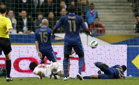 Japan's Shinji Kagawa (bottom, L) dives to score the victory goal for his team over France during their international friendly soccer match Japan's Shinji Kagawa (bottom, L) dives to score the victory goal for his team over France during their international friendly soccer match