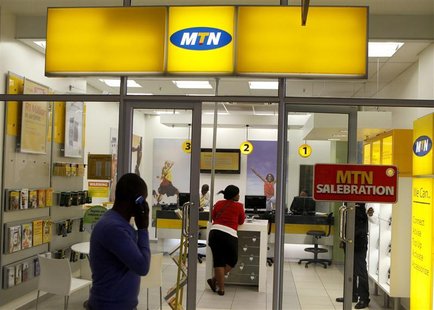 A man speaks on a mobile phone as he walks past a MTN shop at a shopping mall south of Johannesburg June 6, 2012. REUTERS/Siphiwe Sibeko A man speaks on a mobile phone as he walks past a MTN shop at a shopping mall south of Johannesburg June 6, 2012. REUTERS/Siphiwe Sibeko