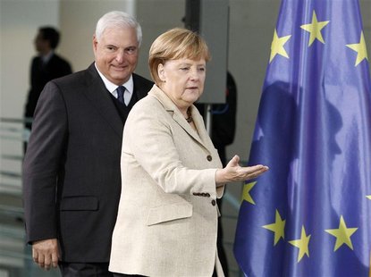 German Chancellor Angela Merkel and Panama's President Ricardo Martinelli arrive for a news conference after talks in Berlin, October 15, 20 German Chancellor Angela Merkel and Panama's President Ricardo Martinelli arrive for a news conference after talks in Berlin, October 15, 20