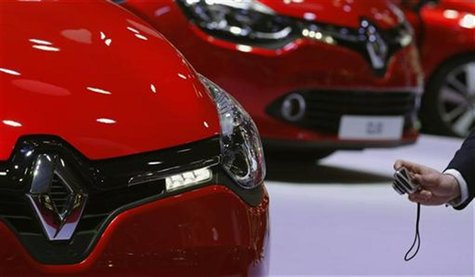 A man takes pictures as he visits the Renault showcase where new Clio cars are displayed on media day at the Paris Mondial de l'Automobile, A man takes pictures as he visits the Renault showcase where new Clio cars are displayed on media day at the Paris Mondial de l'Automobile,