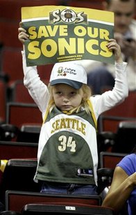 Seattle Supersonics fan Kayla Rydberg, 5, of Auburn, Washington, holds up a "SOS: Save our Sonics" sign before the start of their NBA game a Seattle Supersonics fan Kayla Rydberg, 5, of Auburn, Washington, holds up a "SOS: Save our Sonics" sign before the start of their NBA game a