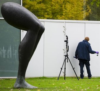 A police officer investigates the surroundings of Rotterdam's Kunsthal art gallery in the Netherlands October 16, 2012. REUTERS/Robin van Lo A police officer investigates the surroundings of Rotterdam's Kunsthal art gallery in the Netherlands October 16, 2012. REUTERS/Robin van Lo