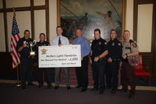 Northern Lights Foundation President Ken Larson receives a check