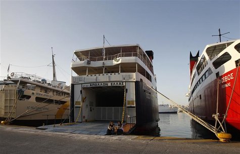 A couple sits at the entrance of an immobilised ferry boat during a 24-hour labour strike in the port of Piraeus, near Athens October 18, 20 A couple sits at the entrance of an immobilised ferry boat during a 24-hour labour strike in the port of Piraeus, near Athens October 18, 20