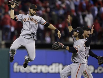 San Francisco Giants center fielder Angel Pagan celebrates with teammates Brandon Crawford and Hunter Pence (R) after their team defeated th San Francisco Giants center fielder Angel Pagan celebrates with teammates Brandon Crawford and Hunter Pence (R) after their team defeated th