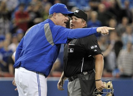 Former Toronto Blue Jays manager John Farrell (L) argues a call with home plate umpire Marvin Hudson during the 10th inning of their MLB Ame Former Toronto Blue Jays manager John Farrell (L) argues a call with home plate umpire Marvin Hudson during the 10th inning of their MLB Ame