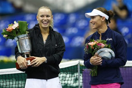 Denmark's Caroline Wozniacki holds her trophy after defeating Australia's Samantha Stosur (R) in the women's singles final at the Kremlin cu Denmark's Caroline Wozniacki holds her trophy after defeating Australia's Samantha Stosur (R) in the women's singles final at the Kremlin cu