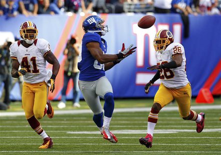 New York Giants Victor Cruz (C) catches the game winning touchdown between Washington Redskins Madieu Willims (L) and Josh Wilson (R) in the New York Giants Victor Cruz (C) catches the game winning touchdown between Washington Redskins Madieu Willims (L) and Josh Wilson (R) in the