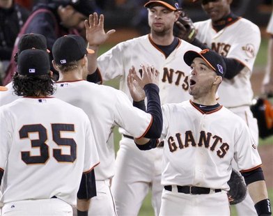 San Francisco Giants second baseman Marco Scutaro (R) celebrates defeating the St. Louis Cardinals with teammate Hunter Pence at the conclus San Francisco Giants second baseman Marco Scutaro (R) celebrates defeating the St. Louis Cardinals with teammate Hunter Pence at the conclus