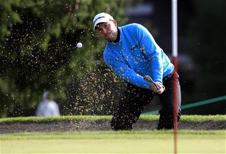 David Howell of England hits out of a bunker onto the 15th green during the third round of the European Masters golf tournament in the Swiss David Howell of England hits out of a bunker onto the 15th green during the third round of the European Masters golf tournament in the Swiss