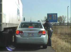Trooper Charles Hotvedt narrowly escapes being hit by a passing semi truck while he was conducting a routine traffic stop on I-94 in Eau Claire County, October 15, 2012 (provided by WisDOT) Trooper Charles Hotvedt narrowly escapes being hit by a passing semi truck while he was conducting a routine traffic stop on I-94 in Eau Claire County, October 15, 2012 (provided by WisDOT)