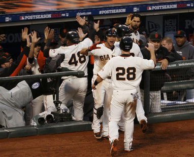 San Francisco Giants catcher Buster Posey (28) is welcomed back to the dugout after scoring against the St. Louis Cardinals in the third inn San Francisco Giants catcher Buster Posey (28) is welcomed back to the dugout after scoring against the St. Louis Cardinals in the third inn