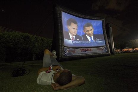 A member of the crowd watches Republican presidential nominee Mitt Romney and U.S. President Barack Obama meet in the final U.S. presidentia A member of the crowd watches Republican presidential nominee Mitt Romney and U.S. President Barack Obama meet in the final U.S. presidentia