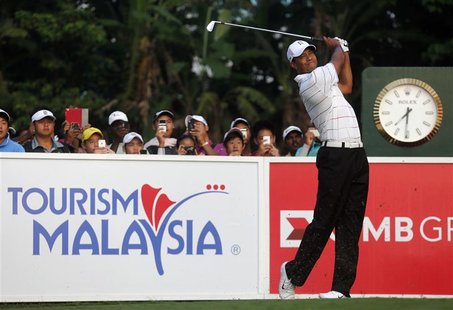 Tiger Woods of the U.S. watches his first shot on the first hole during the Pro-Am ahead of the Malaysia's Asia Pacific Classic golf tournam Tiger Woods of the U.S. watches his first shot on the first hole during the Pro-Am ahead of the Malaysia's Asia Pacific Classic golf tournam