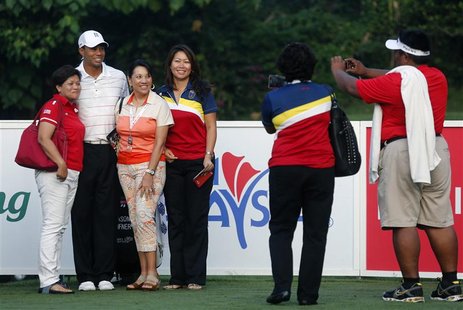 Fans pose wih Tiger Woods (2nd L) of the U.S. as he plays in the Pro-Am ahead of the Malaysia's Asia Pacific Classic golf tournament in Kual Fans pose wih Tiger Woods (2nd L) of the U.S. as he plays in the Pro-Am ahead of the Malaysia's Asia Pacific Classic golf tournament in Kual